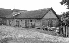 A structure of a half-timbered barn and a brick cowshed