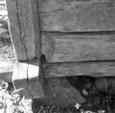 A foundation of a post-and-plank barn